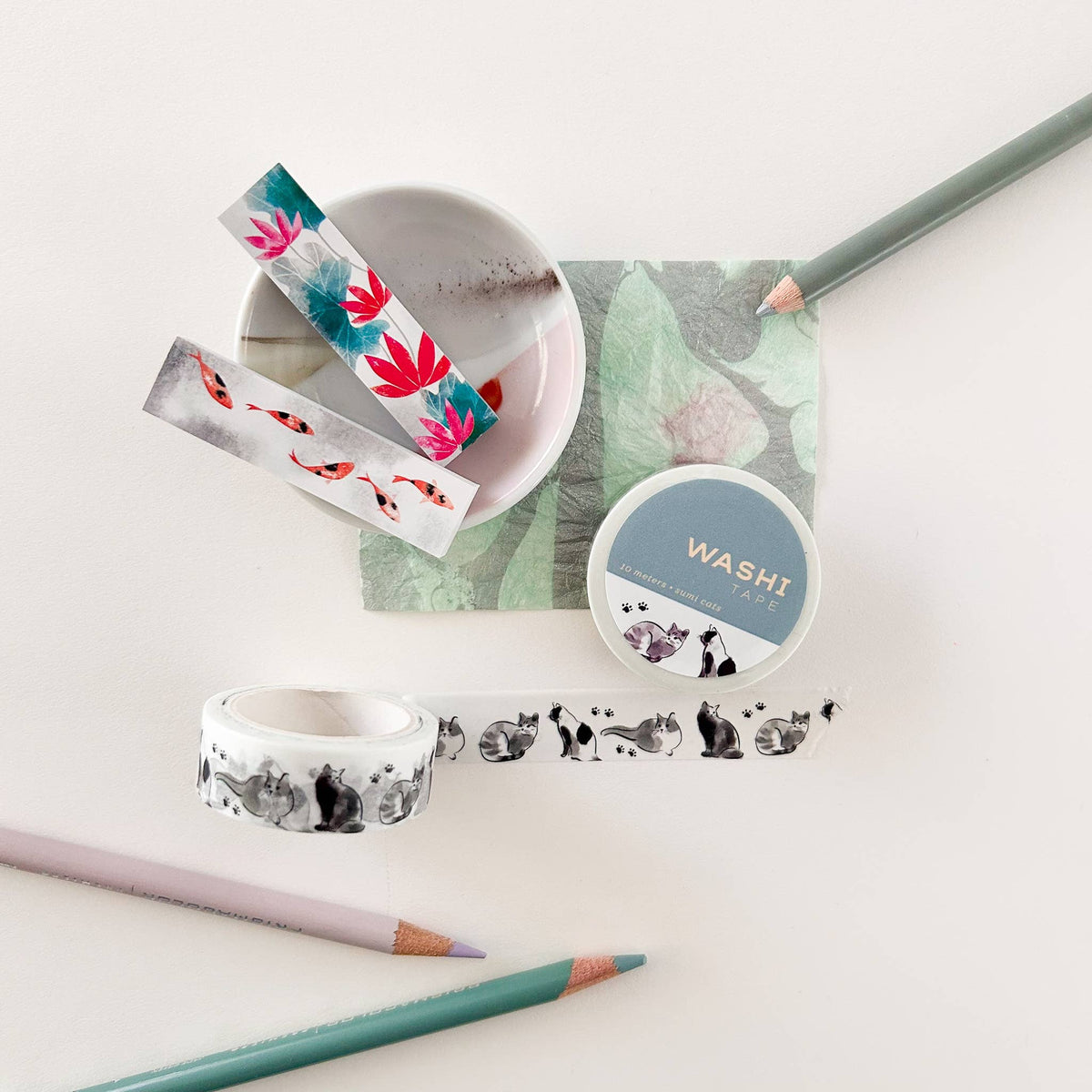 Cat washi tape roll and strip with illustrated black-and-white cats