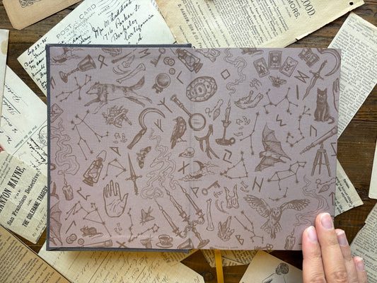 Black B6 notebook with light patterned cover featuring icons and symbols