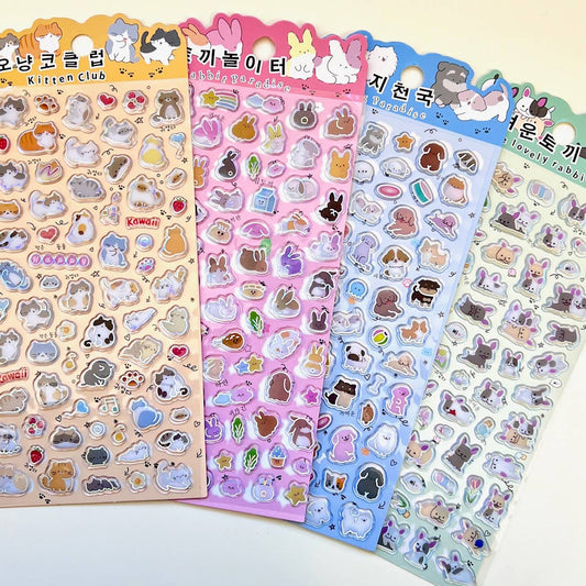 Set of 4 sticker sheets featuring cartoon cats, bunnies, hearts, and small objects in rows.