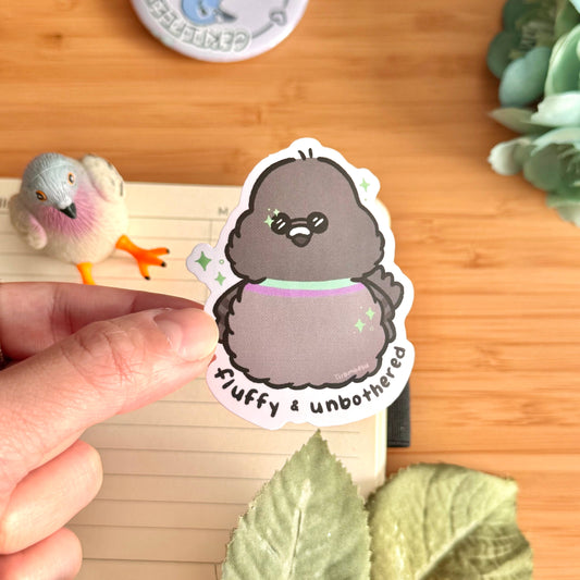 Penguin character sticker with purple scarf, held in hand, white border