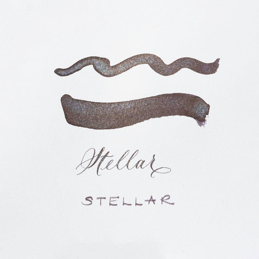 Metallic purple shimmer ink swatches on white card with Stellar label