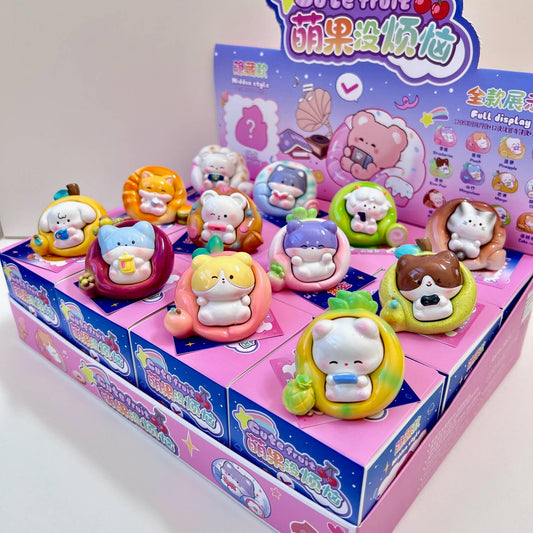 Fruit animal blind box display, multiple cute resin toy figures on a purple box tray