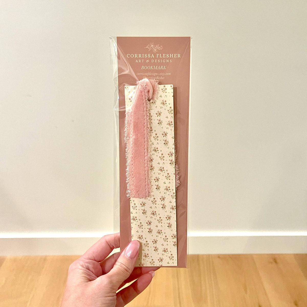 Ditsy floral bookmark with pink velvet ribbon, shown on backing card