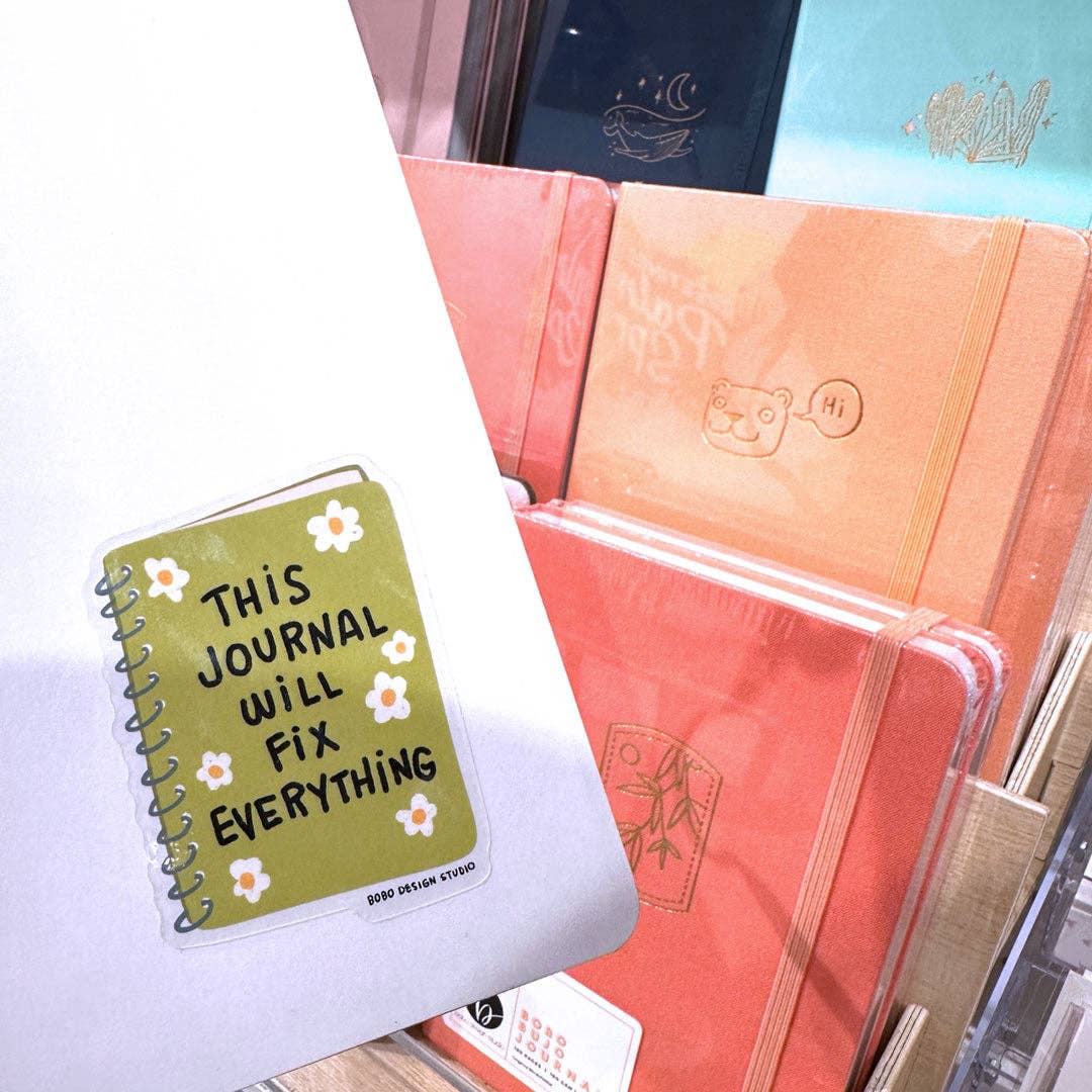 Planner cover vinyl sticker with text "This Journal Will Fix Everything" and white flower accents