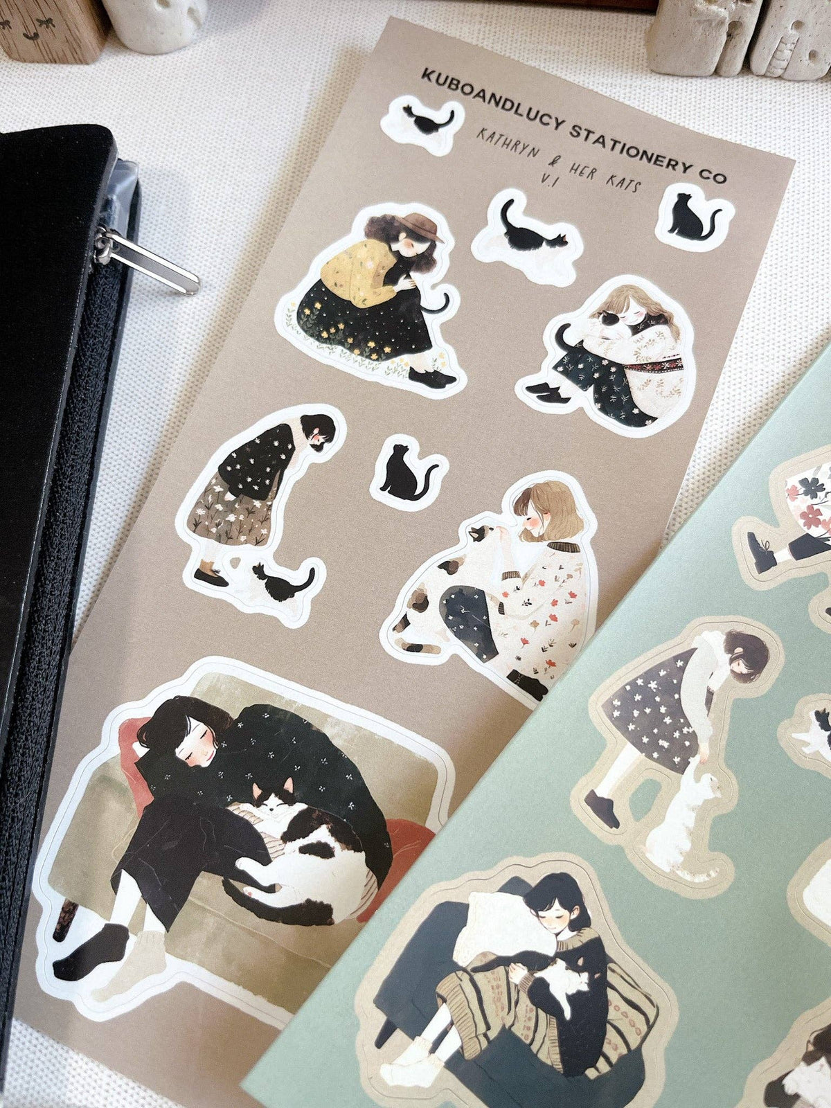 Tan sticker sheet close-up with illustrated cats and paw-print icons