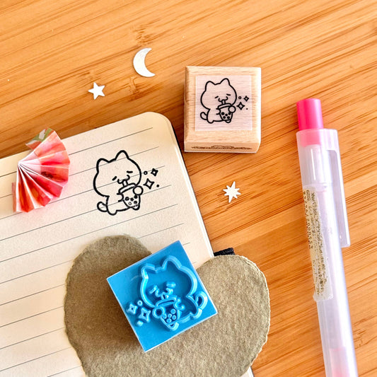 Wooden stamp block showing boba cat outline and small star sparkles