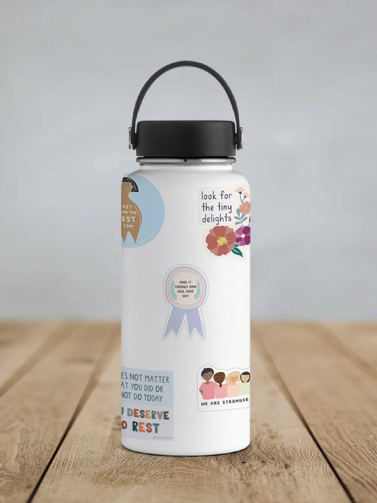 Matte vinyl sticker on white water bottle, round seal with ribbon banner and laurel wreath.