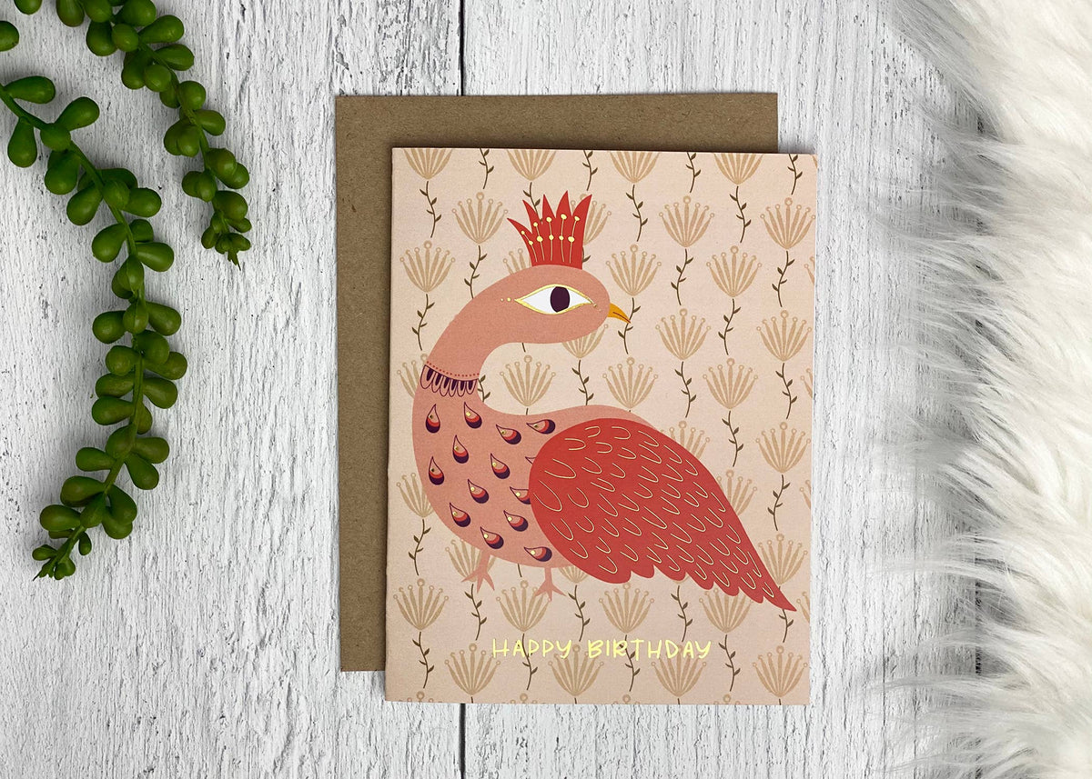 Peacock birthday card with gold foil lettering, feather details, and a brown envelope