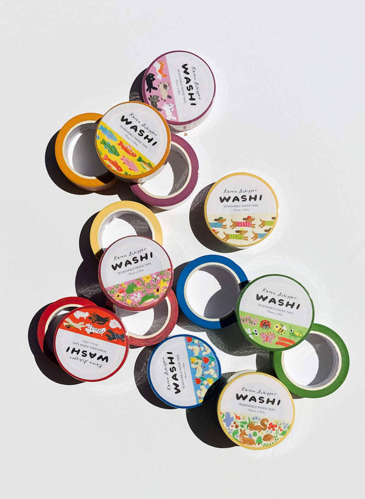 Assorted washi tape rolls with printed labels and colorful patterns, including dachshund designs
