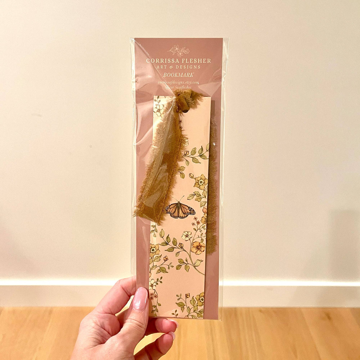 Double-sided bookmark with floral butterfly print and gold velvet ribbon in sleeve