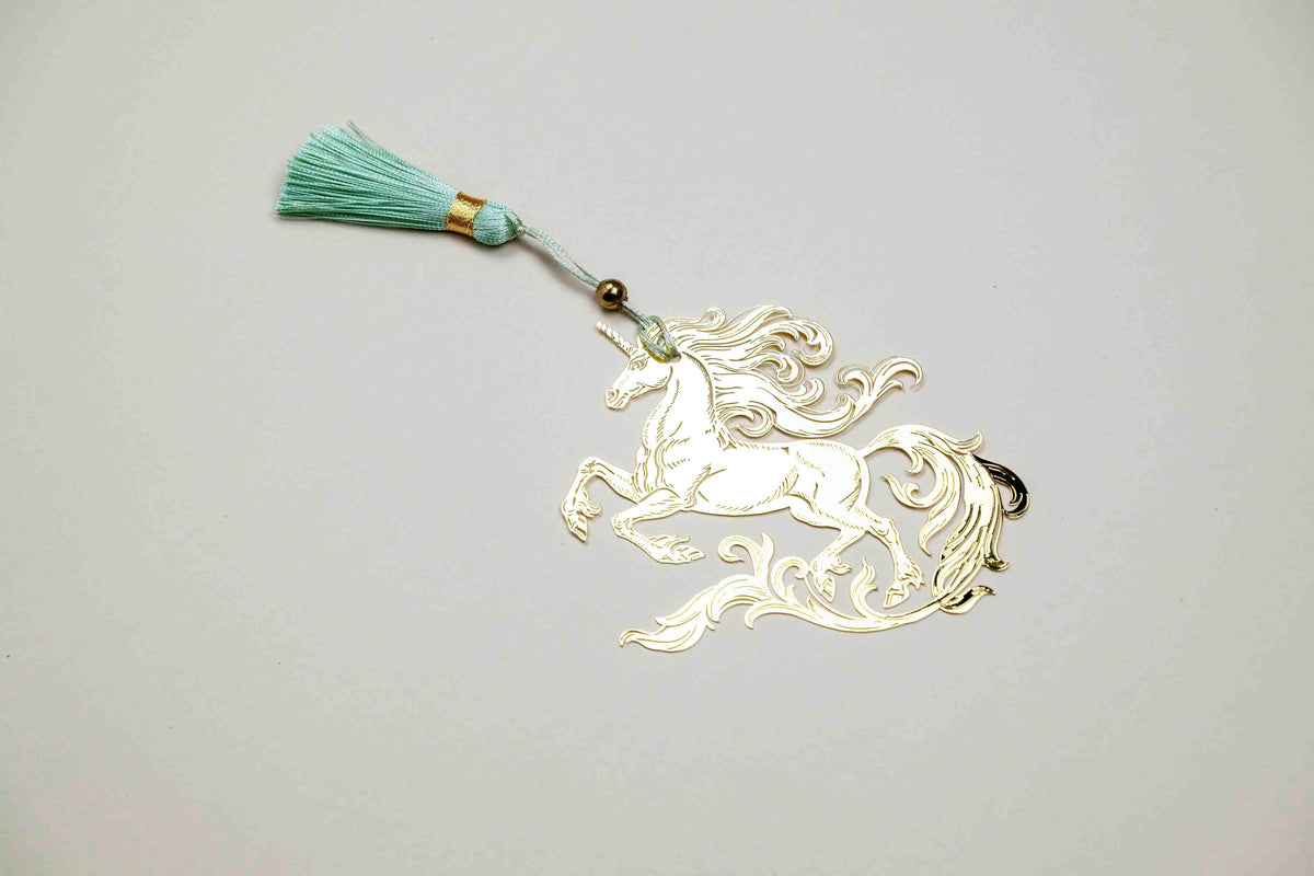 Light gold-tone unicorn bookmark with teal tassel cord and bead