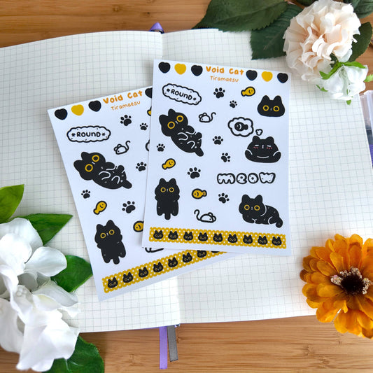 Two void cat sticker sheets with black cat faces, paw prints, and yellow trim