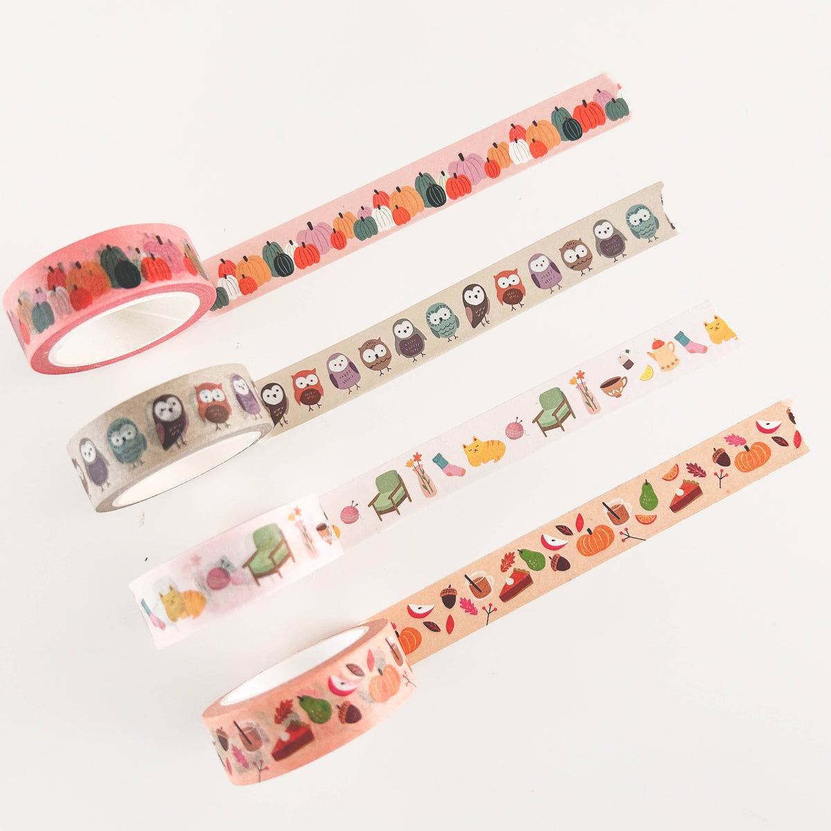 Set of four washi tape rolls with different animal, food, and plant patterns
