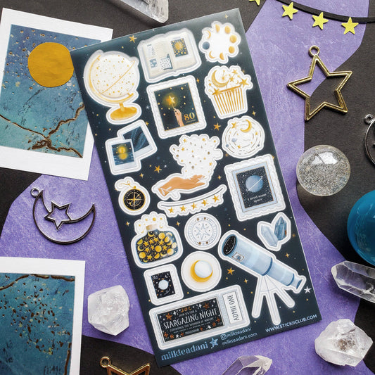 Sticker sheet with space icons: planets, telescope, popcorn, and star symbols
