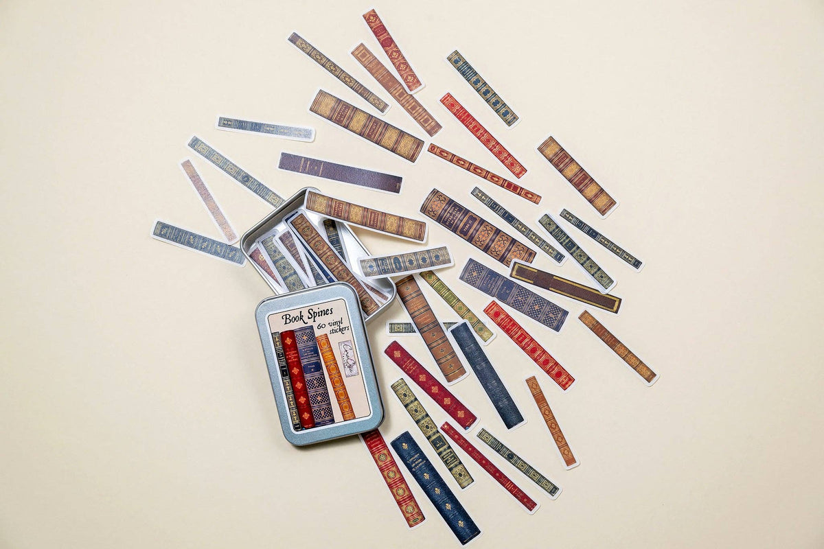 Book spine sticker tin box with many patterned label strips spread out