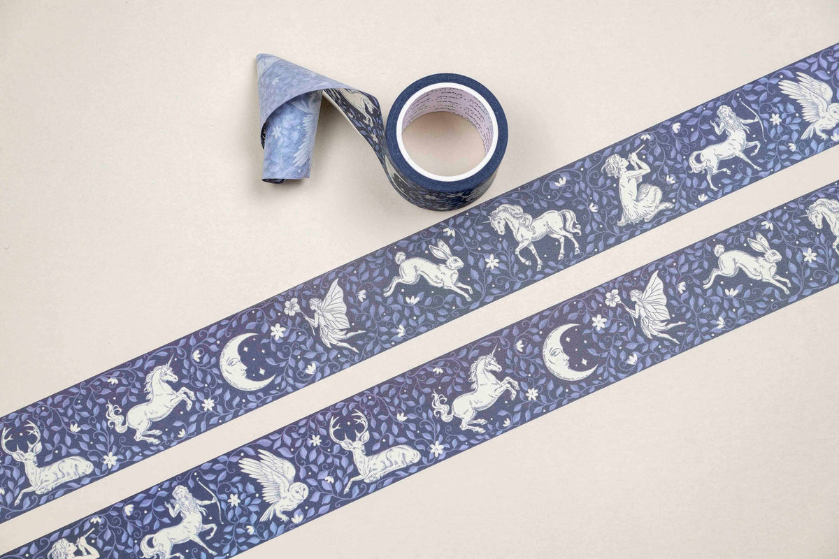 Washi tape roll with two blue strips featuring unicorn, moon, and spark patterns