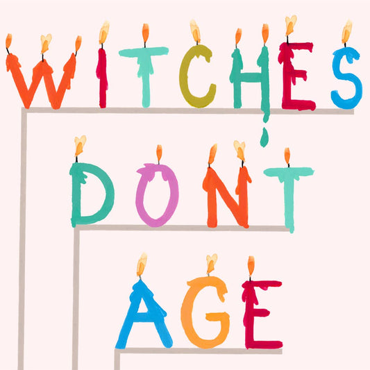 Close-up greeting card text with multicolor candles: WITCHES DON'T AGE