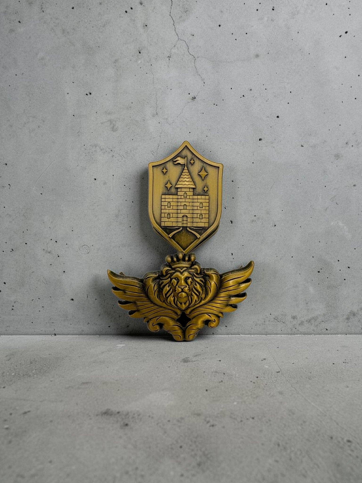 Two-piece gold-toned metal page clip set: shield emblem and winged lion base