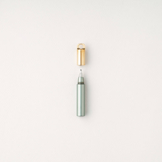 Sage refillable travel pen with open gold cap and slim gray tip
