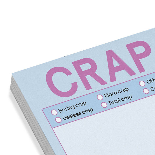 Pastel blue sticky note pad close-up with large pink 'CRAP' lettering