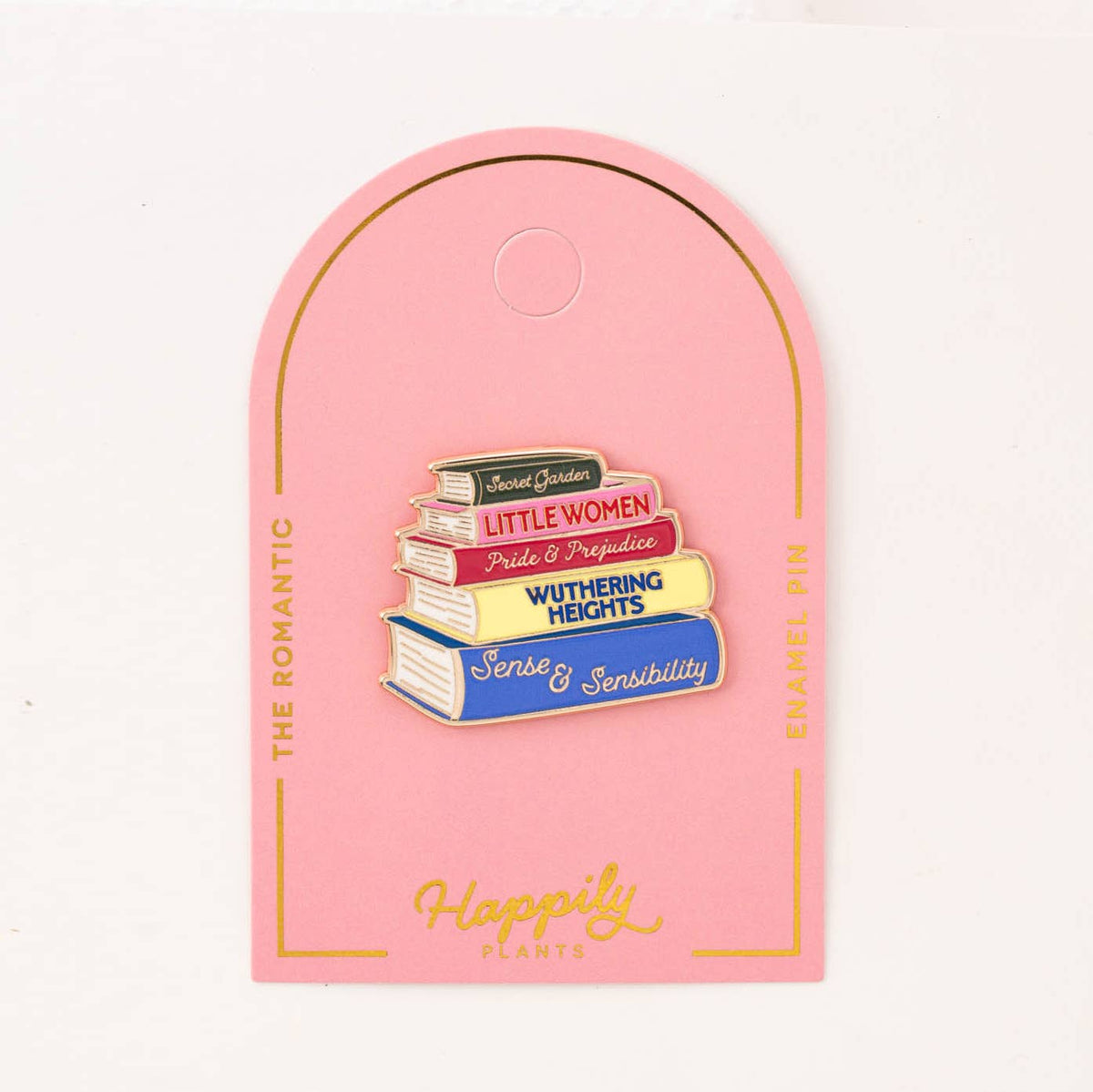 Romantic enamel book pin backing card showing a stacked book pin and 'Happily' text