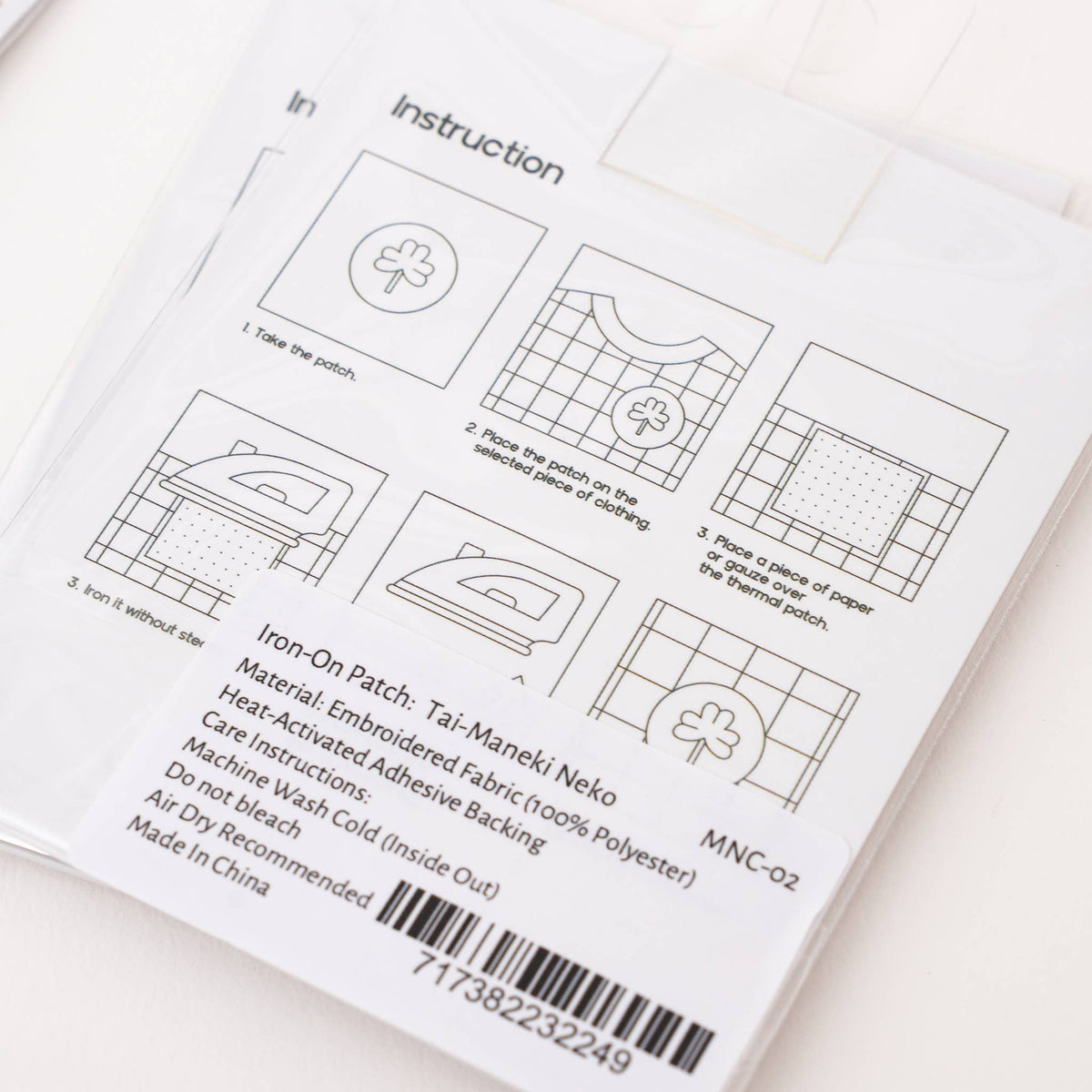 Iron-on patch instruction card with diagrams and barcode on back packaging