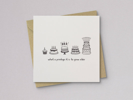 Birthday card with letterpress cake icons and text, on a kraft envelope