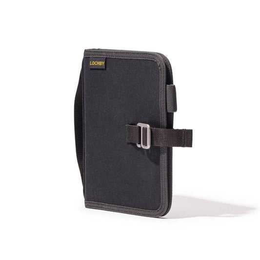 A6 field binder with dark cover, tan-edged spine, and front strap closure