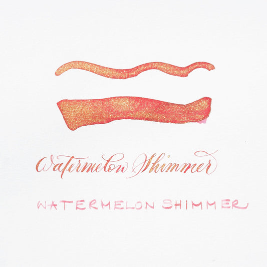 Watermelon shimmer ink swatch with orange-pink glitter lines on white card