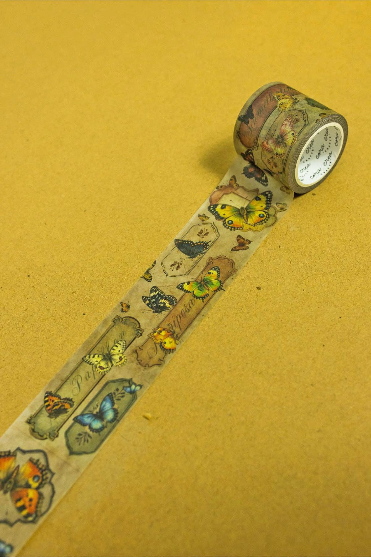 Butterfly washi tape roll with a strip of illustrated butterflies and insects