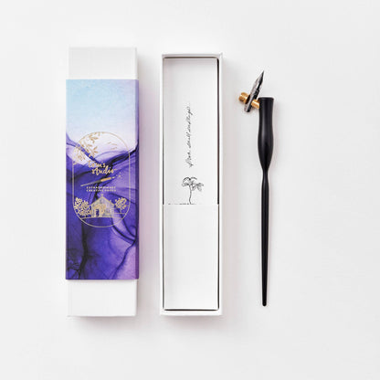 Black flourish calligraphy pen with angled nib and gold accent ring