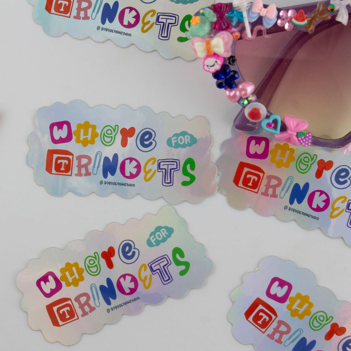 Holographic vinyl sticker set with cloud-shaped 'Whore for Trinkets' designs in blue