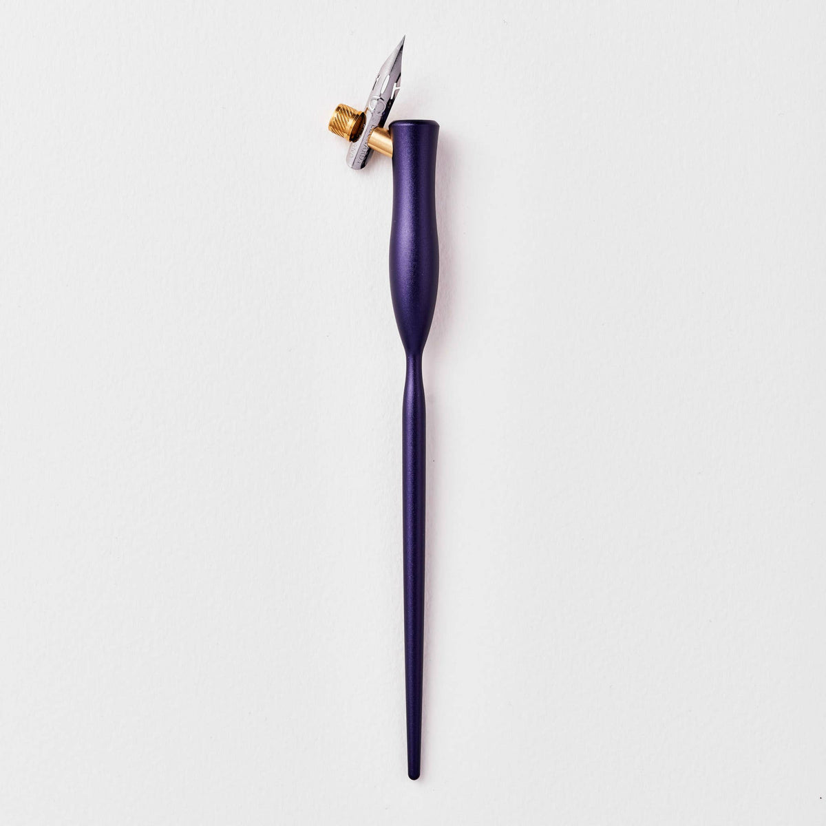 Purple flourish calligraphy pen with angled nib and gold accent ring