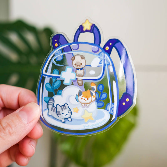 Transparent vinyl sticker showing kittens in a clear bag with blue accents and star shapes