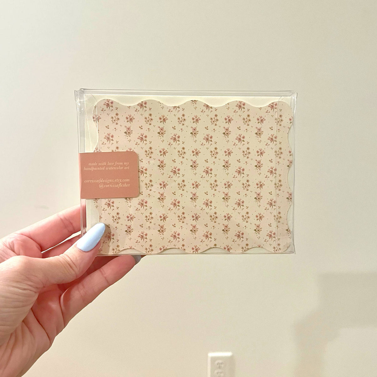 Clear sleeve with beige ditsy floral envelopes and a brown label