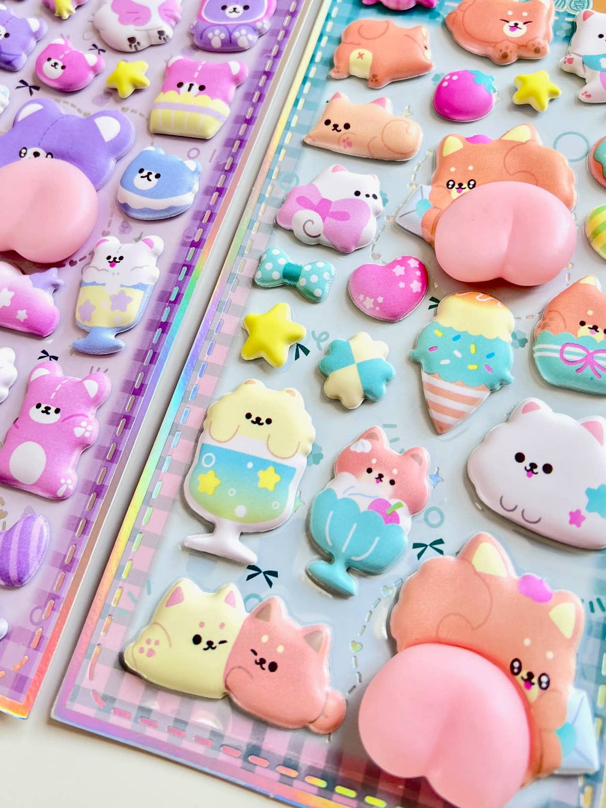 Two animal squishy butt sticker sheets showing pink and purple cat butt and heart stickers