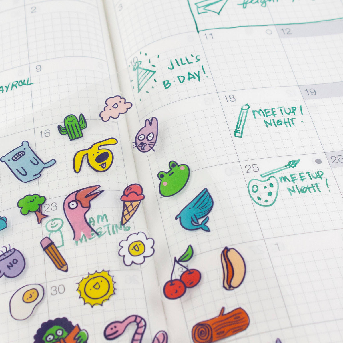 Cartoon stickers from the clear sheet placed on lined planner pages, including “MEETUP NIGHT”