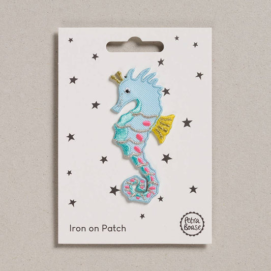Embroidered iron-on seahorse patch with colorful details and glitter accents.