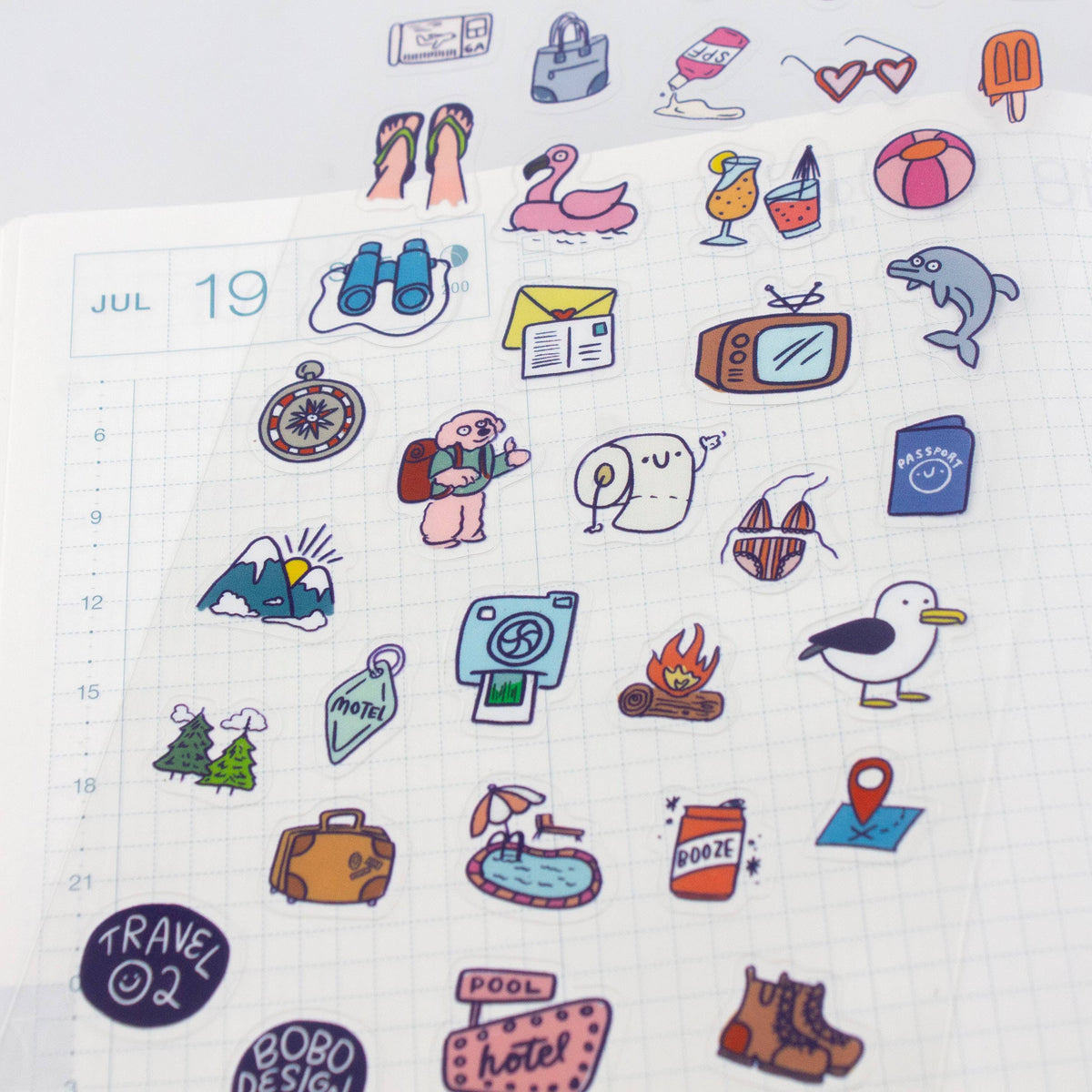 Assorted travel planner stickers featuring hotel, pool, campfire, and penguin designs