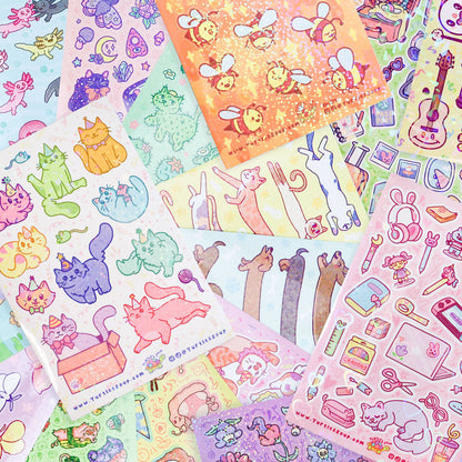 Assorted hamster character sticker sheets spread out with colorful animal decals