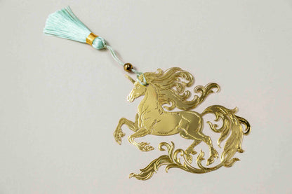 Golden unicorn metal bookmark with teal tassel cord and bead