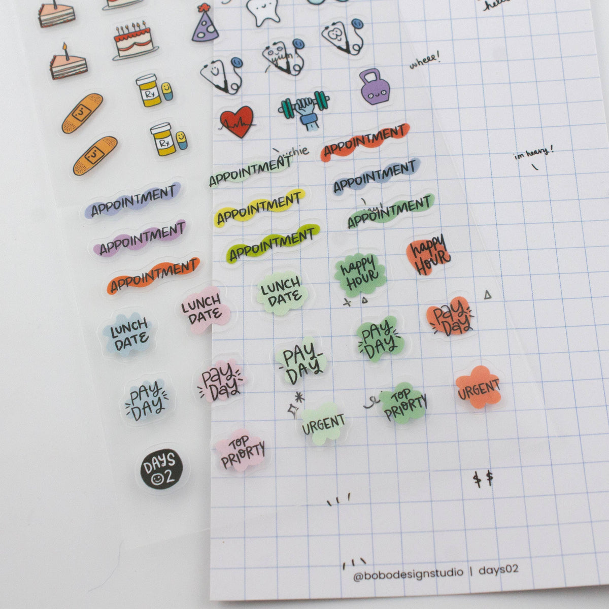 Planner page with applied stickers showing appointment, lunch date, pay day, and urgent text