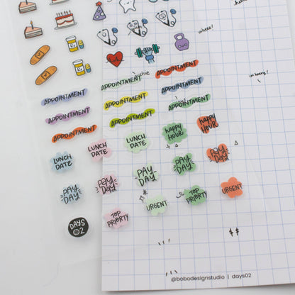Planner page with applied stickers showing appointment, lunch date, pay day, and urgent text