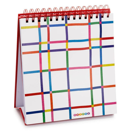 Watercolor pad on red tabletop easel with colorful checkered cover art