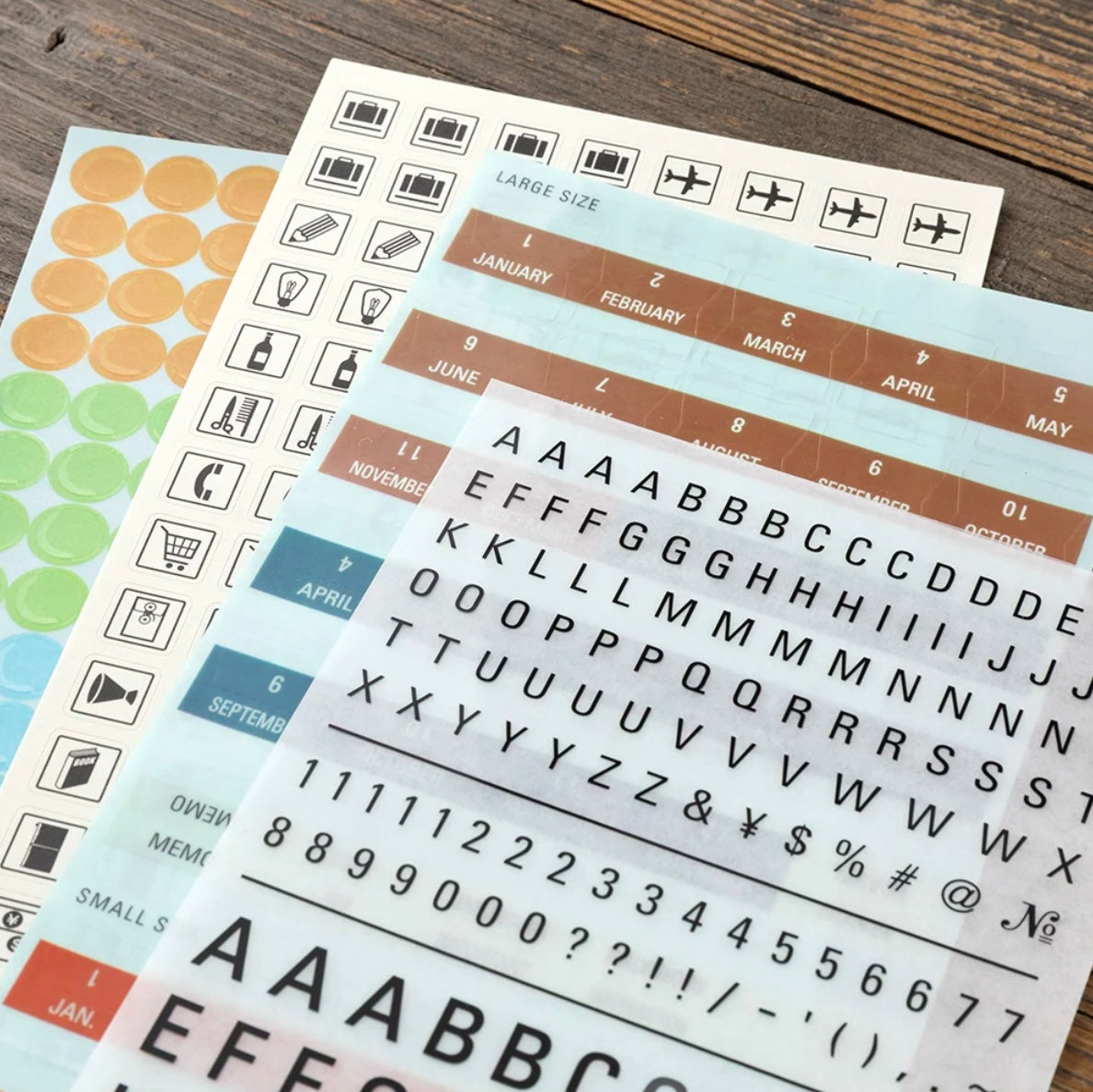 Close-up of letter and number sticker sheet with month strips and symbols for customizing dates