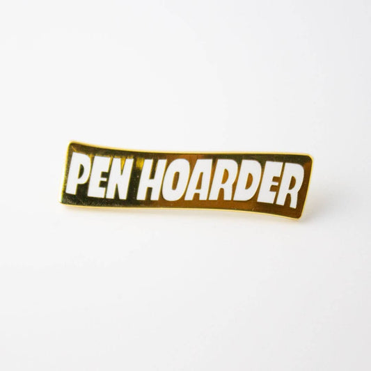 Gold enamel pin with 'Pen Hoarder' lettering