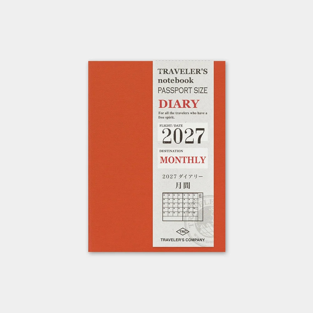 Passport-size 2027 monthly diary notebook with orange cover and calendar layout.