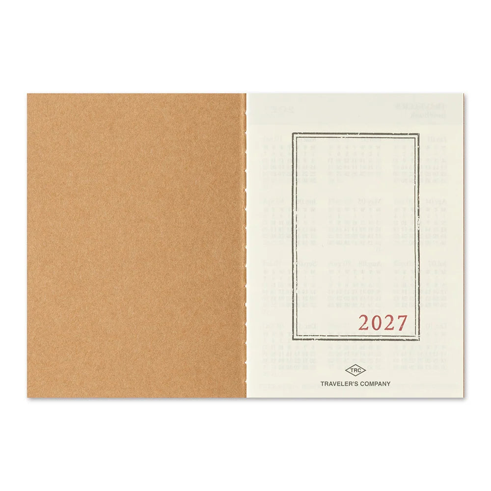 Passport-size diary back cover with tan spine and blank window frame labeled 2027.