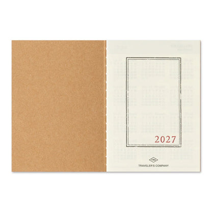 Passport-size diary back cover with tan spine and blank window frame labeled 2027.