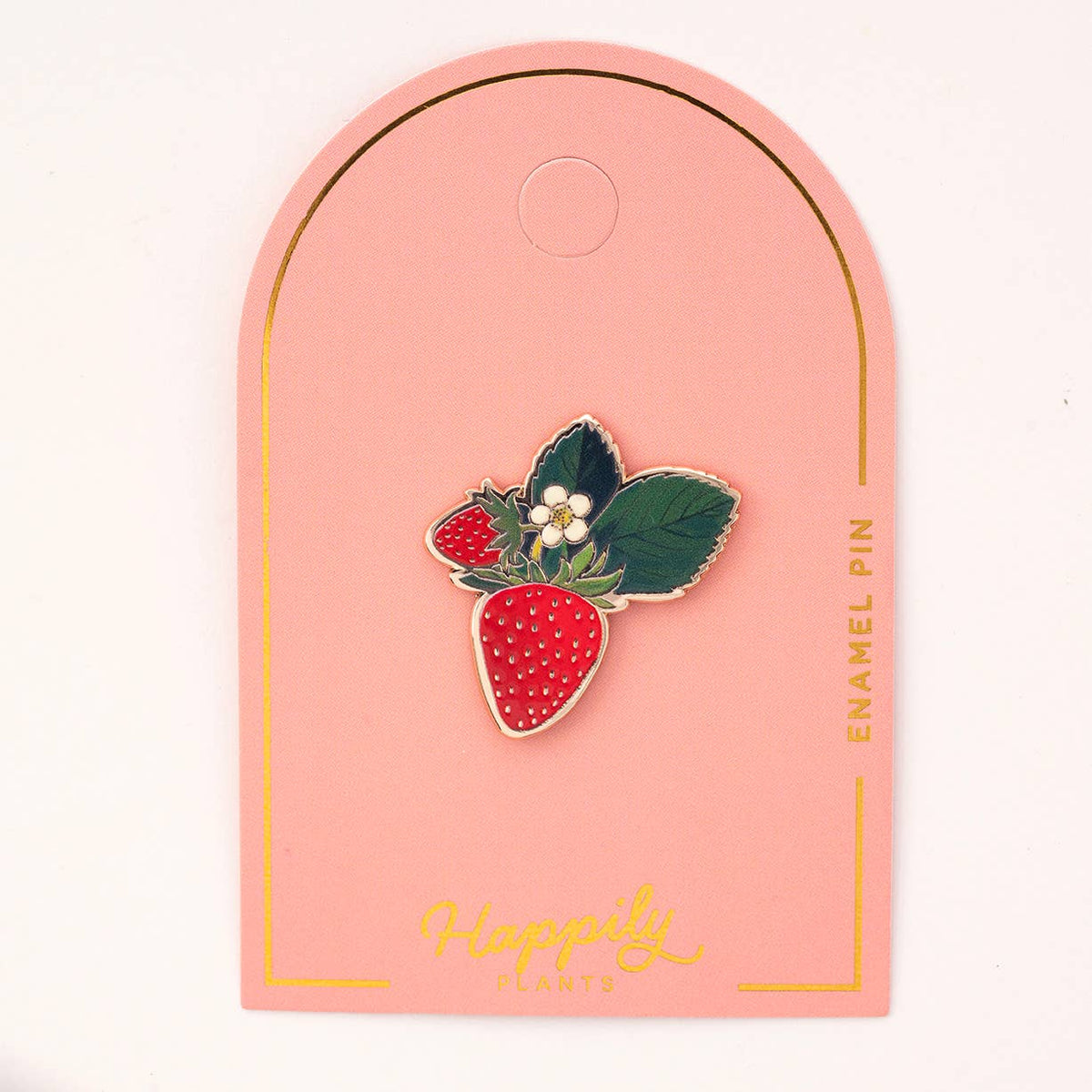 Strawberry blossom enamel pin: red berry with white dots, green leaves, and white flower